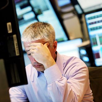  A trader works on the floor of the New York Stock Exchange during late tradingon March 25, 2013 in New York City. 