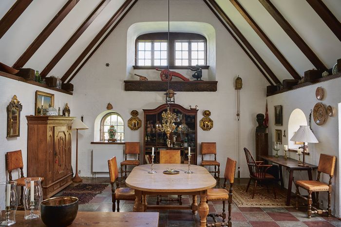 A dining room filled with wooden furniture and a beamed ceiling