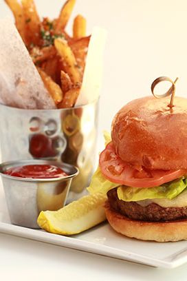 Wagyu chuck, short ribs, capers, caramelized onions, lettuce, tomato, onion on buttered brioche roll with garlic Parmesan French fries