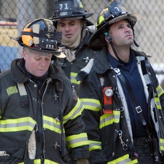 New York City fire crews look up at the building where two firemen were killed and four critically injured in an early morning fire in the Bronx borough of New York Sunday, Jan. 23, 2005.