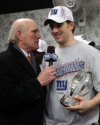 Eli Manning #10 of the New York Giants is interviewed in the locker room by Terry Bradshaw