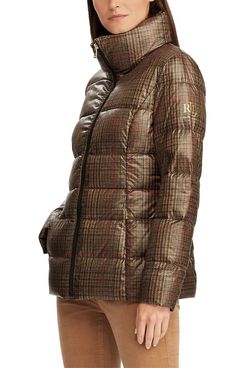 A full zip, high-necked Ralph Lauren Quilted Plaid Down Coat in a small dark brown, cream, and red plaid print with a subtle cream Ralph Lauren logo on the sleeve and tan pants on a model. The Strategist - 33 Things on Sale You’ll Actually Want to Buy: From Adidas to Le Creuset