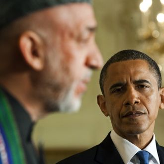 US President Barak Obama (R) listens as Afghanistan President Hamid Karzai (L) speaks during a joint press conference at the White House in Washington, DC, May 12, 2010. President Obama noted Wednesday that visting Afghan counterpart Hamid Karzai had made progress on corruption but said 