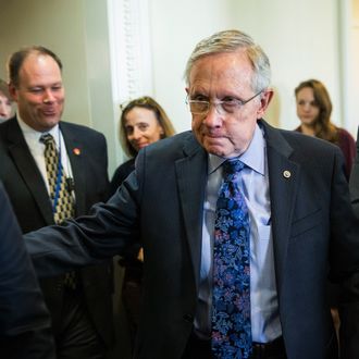 WASHINGTON, DC - OCTOBER 12: Senate Majority Leader Sen. Harry Reid (D-NV) (C) walks through the Capitol building after holding a press conference regarding continuing attempts to end the government shut down on October 12, 2013 in Washington, DC. The shut down is currently in its 12th day. (Photo by Andrew Burton/Getty Images)