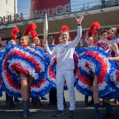 Paris 2024 - The Olympic Flame Stops By The Moulin Rouge