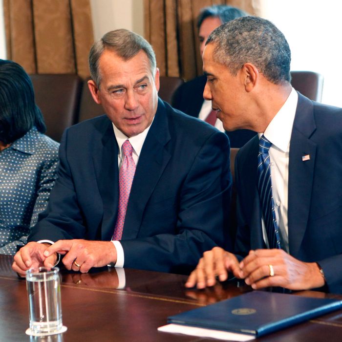 U.S. House Speaker John Boehner (R-OH) (L) speaks with U.S. President Barack Obama as he meets with members of Congress in the cabinet room of the White House on September 3, 2013 .