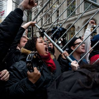 Demonstrators from the Occupy Wall Street movement lift a police barricade at Zucotti park in New York, U.S., on Thursday, Nov. 17, 2011. New York police stood prepared for tens of thousands of Occupy Wall Street demonstrators to descend on the Financial District, and ringed the area with metal barricades to deter crowds from reaching their goal of surrounding the New York Stock Exchange. Photographer: Scott Eells/Bloomberg via Getty Images