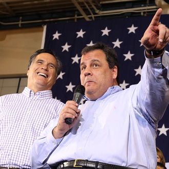 Republican presidential candidate former Massachusetts Gov. Mitt Romney (L) looks on as New Jersey Gov. Chris Christie (R) speaks during a rally at Exeter High School on January 8, 2012 in Exeter, New Hampshire. 