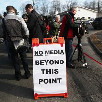 NEWTOWN, CT - DECEMBER 15: Media gather near a makeshift memorial outside a firehouse which was used as a staging area for families following the mass shooting at Sandy Hook Elementary School on December 15, 2012 in Newtown, Connecticut. Twenty six people were shot dead, including twenty children, after a gunman identified as Adam Lanza in news reports opened fire in the school. Lanza also reportedly had committed suicide at the scene. (Photo by Mario Tama/Getty Images)