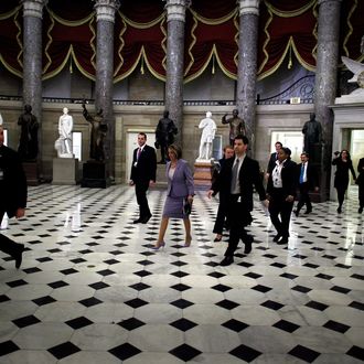 Speaker of the House Nancy Pelosi (D-CA) (C) walks through Statuary Hall on her way to the House Chamber ahead of a historic vote on health care reform at the U.S. Capitoll March 21, 2010 in Washington, DC. 