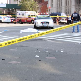 Crime scene tape blocks intersection of Fourth, Flatbush and Atlantic Aves with covered body of a bicyclist who was fatally struck by SUV witnesses said was attempting to flee the scene of an accident on Fourth and Dean Aves in Brooklyn on July 13, 2015