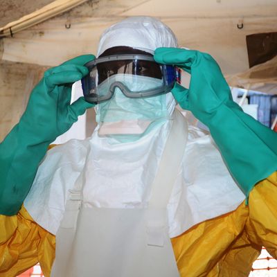 A picture taken on June 28, 2014 shows a member of Doctors Without Borders (MSF) putting on protective gear at the isolation ward of the Donka Hospital in Conakry, where people infected with the Ebola virus are being treated. The World Health Organization has warned that Ebola could spread beyond hard-hit Guinea, Liberia and Sierra Leone to neighbouring nations, but insisted that travel bans were not the answer. To date, there have been 635 cases of haemorrhagic fever in Guinea, Liberia and Sierra Leone, most confirmed as Ebola. A total of 399 people have died, 280 of them in Guinea. AFP PHOTO / CELLOU BINANI (Photo credit should read CELLOU BINANI/AFP/Getty Images)