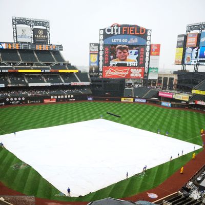 NEW YORK, NY - SEPTEMBER 15: Fans wait in the rain during a rain delay in the second inning during a game between the Washington Natinoals and New York Mets at Citi Field on September 15, 2011 in the Flushing neighborhood of the Queens borough of New York City. (Photo by Patrick McDermott/Getty Images)