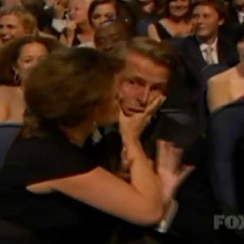 Jack McBrayer is pretending to be grossed out about being kissed by Tina Fey. But why exactly does the woman in red behind him seem legitimately disgusted on his behalf?
