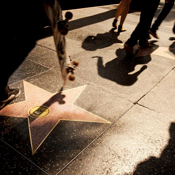Pedestrians pass Alfred Hitchcock's star on the Walk of Fame in Hollywood, California, U.S. on Friday, July 22, 2011. Los Angeles, which is selling $380 million in debt, may benefit from demand for California bonds with long-term issuance at the lowest since 2000. Photographer: Konrad Fiedler/Bloomberg via Getty Images