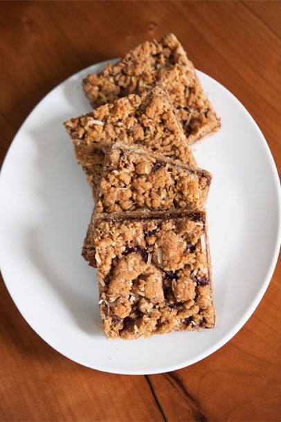 Raspberry Coconut Crumb Bars made with sprouted spelt flour, coconut flakes, maple syrup, canola oil, arrowroot, baking powder, vanilla extract, sea salt, and fruit-juice sweetened raspberry jam.