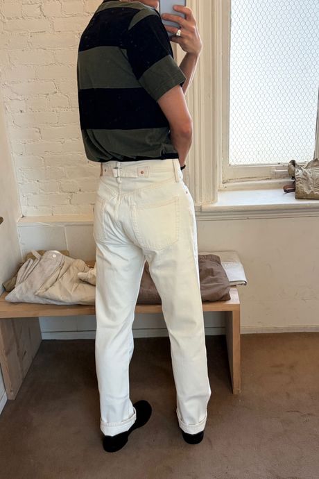 Man in white jeans facing away from the camera
