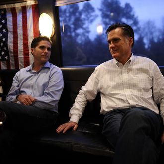 Republican presidential hopeful Mitt Romney rides his campaign bus between Gilbert and Charleston, South Carolina, January 20, 2012. South Carolina will hold its Republican primary on January 21, 2012. (L-R) granddaughter Allie and son Tagg. 