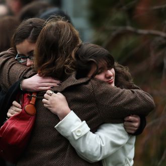 Three women embrace as they arrive for the funeral services of six year-old Noah Pozner, who was killed in the shooting massacre in Newtown, CT, at Abraham L. Green and Son Funeral Home on December 17, 2012 in Fairfield, Connecticut. Today is the first day of funerals for some of the twenty children and seven adults who were killed by 20-year-old Adam Lanza on December 14, 2012.