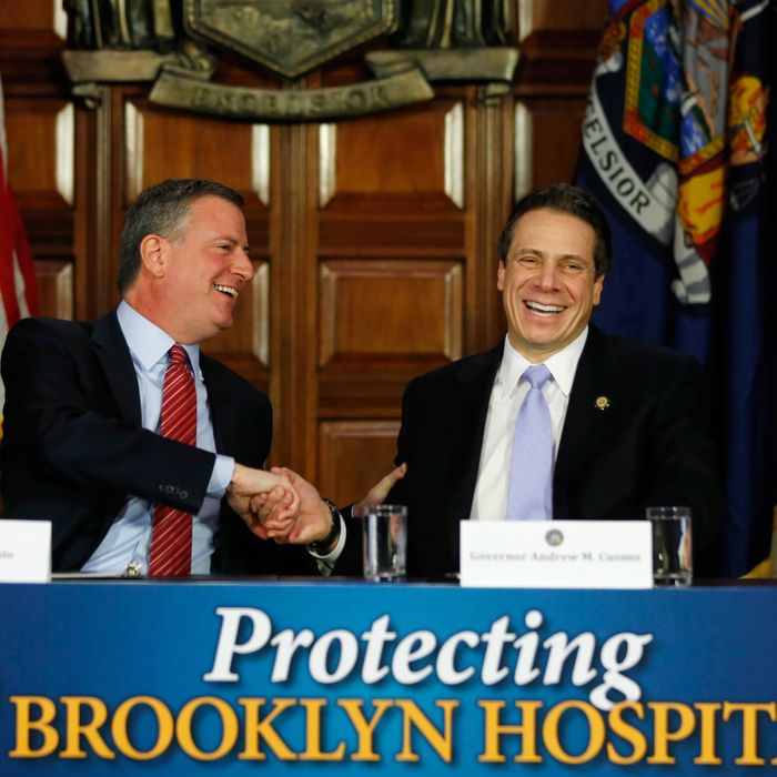 New York City Mayor Bill de Blasio, left, and New York Gov. Andrew Cuomo shake hands during a news conference in the Red Room at the Capitol on Monday, Jan. 27, 2014, in Albany, N.Y. De Blasio is urging state lawmakers to support his proposed tax hike on wealthy city residents to pay for universal prekindergarten. (AP Photo/Mike Groll)