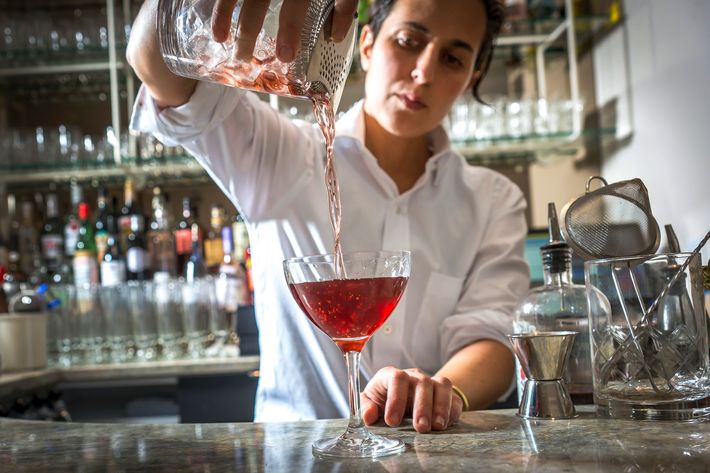 Bartender Soraya Odishoo making the Oakland cocktail, which includes smoked red wine, bitters, and golden rum.