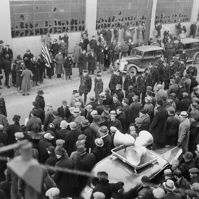 02 Feb 1937, Flint, Michigan, USA ---Here is the scene at Chevrolet Parts Plant No. 9, in Flint,where 12 persons were injured as Union Pickets,including about 75 women clashed w/ Company police in the latest outbreak of violence in the sit-down automobile strike.Sheriff Thomas Wolcott has demanded National guardsmen to prevent further trouble. The strikers' sound truck which sounded the call to arms is in the foreground. Police used tear gas against Pickets' stones and clubs. 