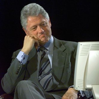 WASHINGTON, : US President Bill Clinton looks at the computer screen as he participates in the Democratic Leadership Council/Excite On Line Town Hall Meeting late 08 November 1999 at the Marvin Center Auditorium at George Washington University. The town hall meeting was conducted over the internet. (ELECTRONIC IMAGE) AFP Photo by Paul J. Richards (Photo credit should read PAUL J. RICHARDS/AFP/Getty Images)