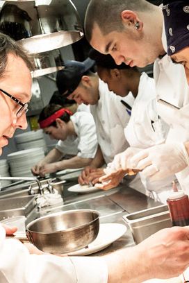 Chef Telepan finishes off his dish on the line.