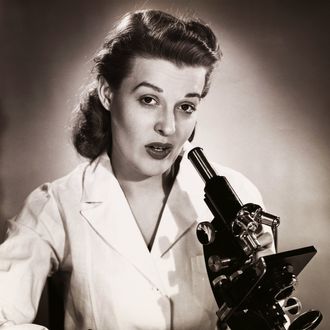 Portrait of a female scientist using a microscope