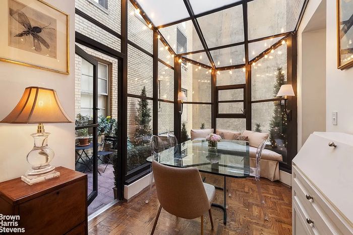 A listing photo for a Museum Mile one-bedroom with a terrarium-like dining area