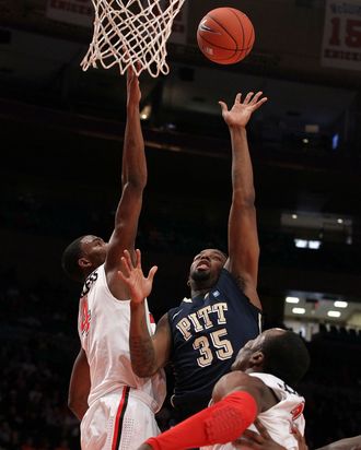 Nasir Robinson #35 of the Pittsburgh Panthers puts up a shot against Moe Harkless #4 of the St. John's Red Storm