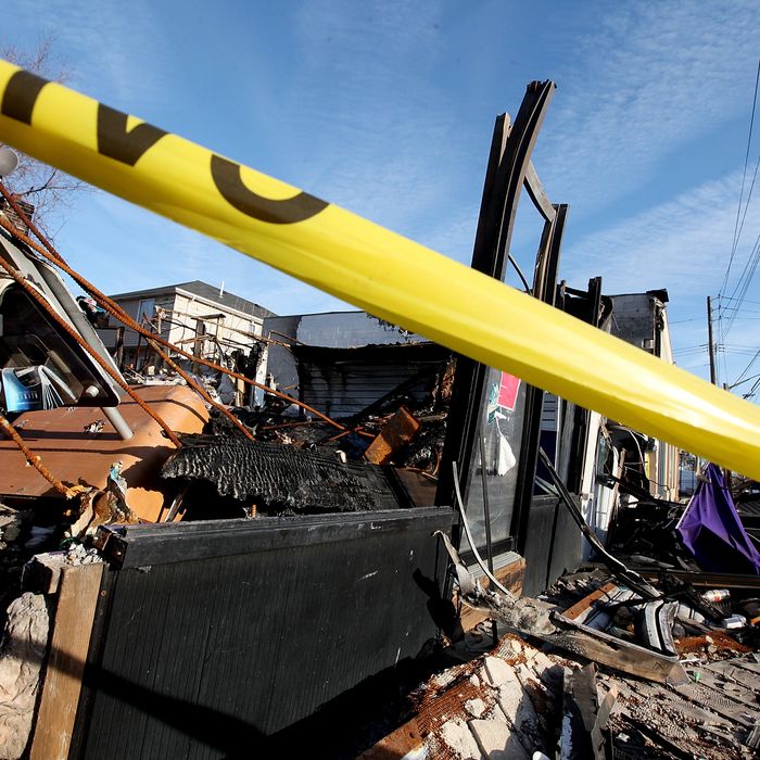 A property destroyed by fire following Superstorm Sandy remains blocked by police tape in the Midland Beach neighborhood which was heavily damaged by Sandy on December 23, 2012 in the Staten Island borough of New York City. Staten Island was hit hard by Sandy and some homes and businesses remain without power.