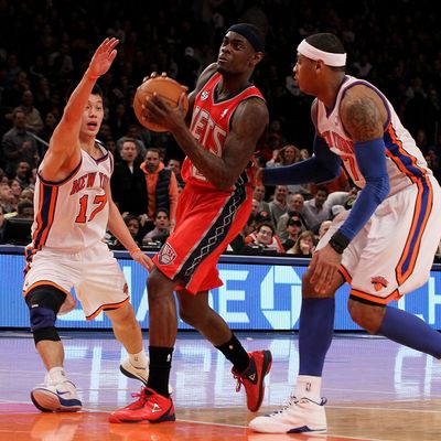 Anthony Morrow #22 of the New Jersey Nets in action against Jeremy Lin #17 and Carmelo Anthony #7 of the New York Knicks