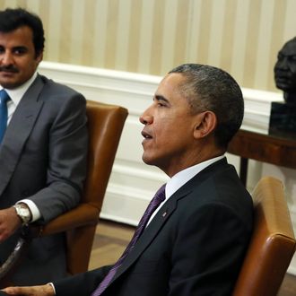 U.S. President Barack Obama (R) meets with Amir of Qatar, His Highness Sheikh Tamim bin Hamad al Thani in the Oval Office of the White House February 24, 2015 in Washington, DC.