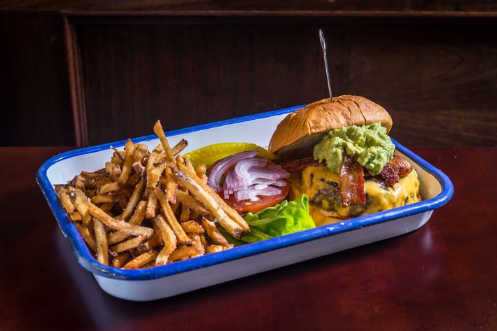 Lower East Side burger with bacon, guacamole, Vermont cheddar, and AG sauce.