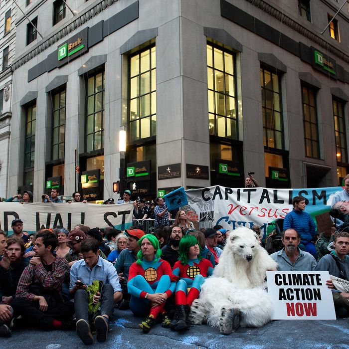 NEW YORK, NY - SEPTEMBER 22: Demonstrators sit in the middle of Broadway during the Flood Wall Street protest on September 22, 2014 in New York City. The Flood Wall Street protest came on the heels of the climate change march on September 21 that attracted over 300,000 protestors. (Photo by Bryan Thomas/Getty Images)