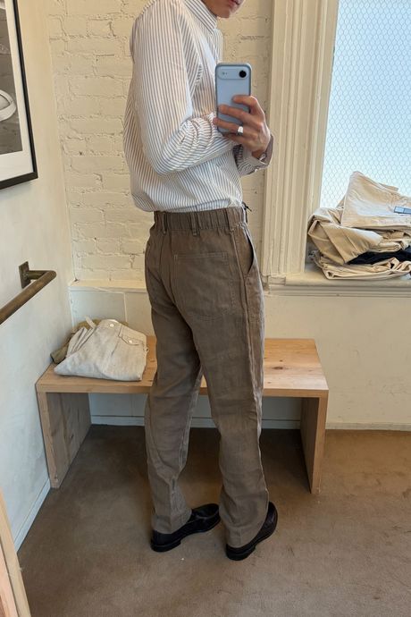 man in brown pants facing away from the camera