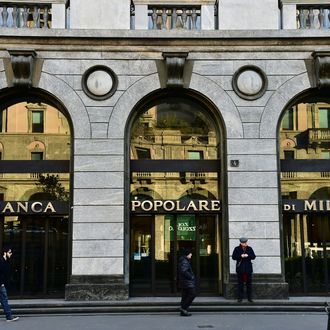 People walk past a branch of Banca Popolare di Milano bank on January 19, 2016 in Milan.