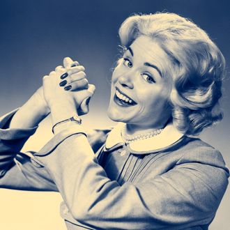 05 Feb 1959 --- 1950s 1960s Woman Making Winning Symbolic Hand Gesture With Raised Clasped Hands --- Image by ? H. Armstrong Roberts/ClassicStock/Corbis