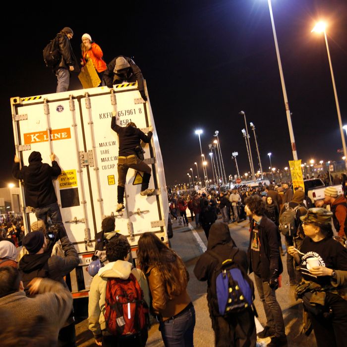 Occupy Wall Street protesters gather in front of a terminal gate of the Port of Oakland to try to shutdown the port as a part of the West Coast port blockage on December 12, 2011 in California. AFP Photo / Kimihiro Hoshino (Photo credit should read KIMIHIRO HOSHINO/AFP/Getty Images)