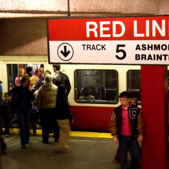 People entering and leaving the Red Line subway station in Boston, MA where the subway is known as the T.