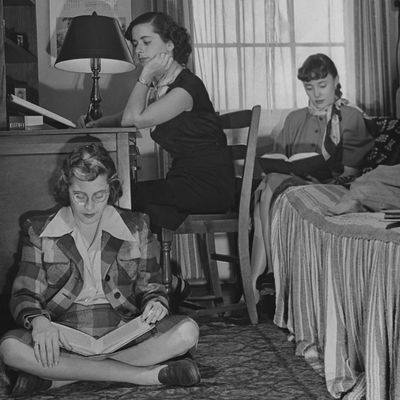 Four women in a 1950s dorm.