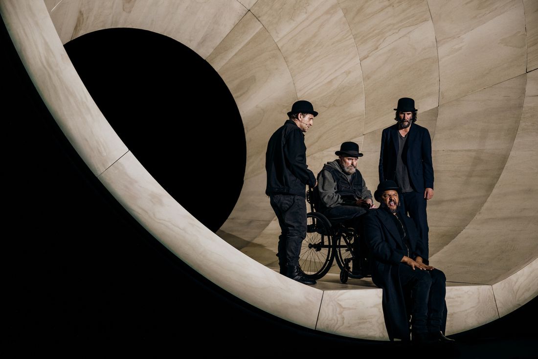 (L to R): Alex Winter as ‘Vladimir,’ Michael Patrick Thornton as ‘Lucky’ (in wheel chair), Brandon J. Dirden as ‘Pozzo’ (seated on stage), and Keanu Reeves as ‘Estragon.’