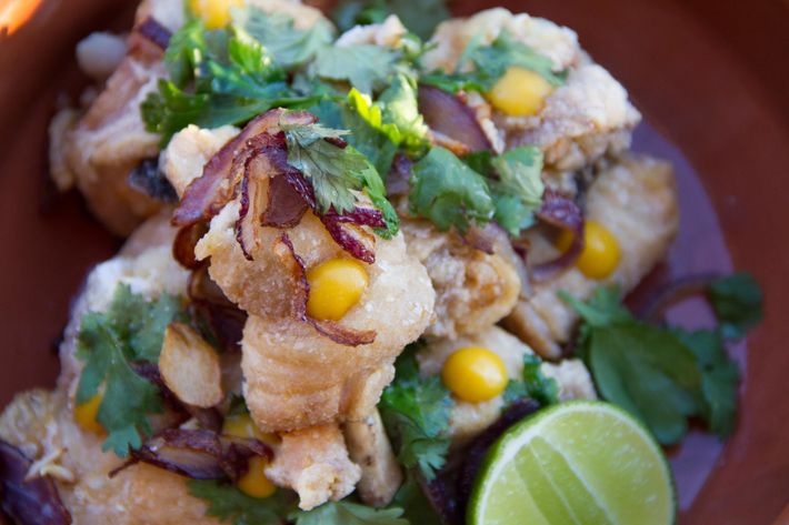 Chicken chicharrones with garlic, red onions, herbs, and lime.