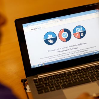 MIAMI, FL - OCTOBER 08: A message is seen on the computer indicating that there are too many visitors on the Affordable Care Act site to continue, as navigator Nini Hadwen helps people shop for health insurance during a navigation session put on by the Epilepsy Foundation Florida to help people sign up for health insurance under the Affordable Care Act on October 8, 2013 in Miami, Florida. The United States government continues to be partially shut down as Republicans hold out hope to cut funding for the Affordable Care Act. (Photo by Joe Raedle/Getty Images)