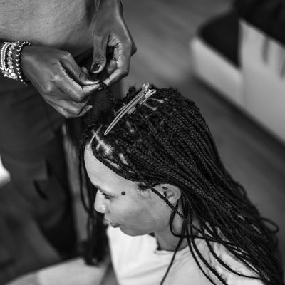 Black Female Hairstylist Working on Mixed Race Female Client at Home