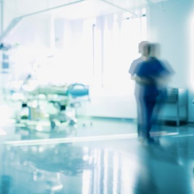 Blurry photo of nurse in hospital room.