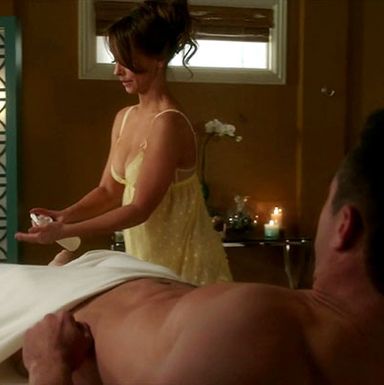 She's squirting lotion into her hands because she's about to give a hand job.