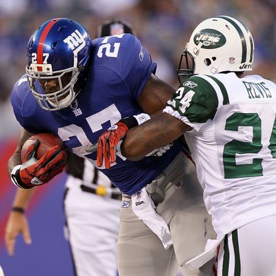 Brandon Jacobs #27 of the New York Giants runs the ball against Darrelle Revis #24 of the New York Jets during their pre season game on August 29, 2011 at MetLife Stadium in East Rutherford, New Jersey.