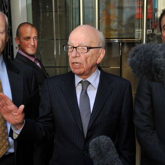 News Corporation Chief Rupert Murdoch (C) speaks to the media after meeting the family of murdered British school girl Milly Dowler in London, on July 15, 2011. Rupert Murdoch will use advertisements in British national newspapers on Saturday to apologise for 